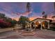 Elegant home featuring a circular driveway, a fountain, a tiled roof, and beautiful arched architecture at 5254 E Arroyo Rd, Paradise Valley, AZ 85253