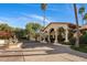 Home exterior with a water feature, arched entrance and meticulously landscaped yard at 5254 E Arroyo Rd, Paradise Valley, AZ 85253