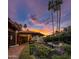 Picturesque exterior of a home with a covered patio, manicured garden, and stunning sunset views at 5254 E Arroyo Rd, Paradise Valley, AZ 85253