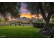 Lush front yard view with desert landscaping and mature trees, framing a picturesque view of the mountains at 5254 E Arroyo Rd, Paradise Valley, AZ 85253