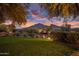 Expansive front yard view featuring desert landscaping and mature trees, framing a picturesque view of the mountains at 5254 E Arroyo Rd, Paradise Valley, AZ 85253