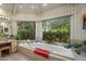 Bright main bathroom featuring a garden tub, dual vanities, and a large window at 5254 E Arroyo Rd, Paradise Valley, AZ 85253