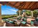 Inviting outdoor living space with comfortable seating and fireplace, overlooking a stunning view and manicured foliage at 5254 E Arroyo Rd, Paradise Valley, AZ 85253