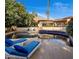 Stunning pool and lounging area with mountain views, surrounded by lush landscaping and a beautiful terrace at 5254 E Arroyo Rd, Paradise Valley, AZ 85253