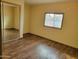 Bedroom featuring a window, closet with mirrored sliding doors, and a light brown wall color at 549 E Mckellips Rd # 55, Mesa, AZ 85203