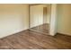 Bedroom with wood floors, a closet with mirrored sliding doors, and light paint at 549 E Mckellips Rd # 55, Mesa, AZ 85203