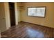 Bedroom featuring newer floors, closet, shelves and a window for natural light at 549 E Mckellips Rd # 55, Mesa, AZ 85203