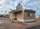 Exterior of a mobile home featuring a covered front porch, desert landscaping and a number '55' on the side at 549 E Mckellips Rd # 55, Mesa, AZ 85203