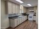 Bright kitchen showcasing light cabinets, dark countertops, tile backsplash and modern appliances on newer floors at 549 E Mckellips Rd # 55, Mesa, AZ 85203