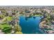 An aerial view of a vibrant Freeman Farms lake surrounded by lush trees, neighborhood homes and community park at 5779 S Penrose Dr, Gilbert, AZ 85298