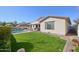 Lush backyard featuring a sparkling pool, manicured lawn, and covered patio perfect for entertaining at 5779 S Penrose Dr, Gilbert, AZ 85298