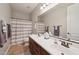 Well-lit bathroom with a dual vanity, neutral walls, and shower-tub combination at 5779 S Penrose Dr, Gilbert, AZ 85298