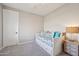 Neutral bedroom with daybed, bedside table, and carpeted floor at 5779 S Penrose Dr, Gilbert, AZ 85298