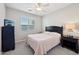 Simple bedroom with neutral carpet, fan, a queen bed, and a good source of natural light at 5779 S Penrose Dr, Gilbert, AZ 85298