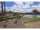 Landscaped community entrance featuring a pond, waterfall, and lush greenery for a welcoming atmosphere at 5779 S Penrose Dr, Gilbert, AZ 85298