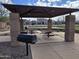 Community picnic area with picnic tables and BBQ grill in a covered ramada with stone posts at 5779 S Penrose Dr, Gilbert, AZ 85298