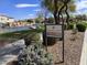 Welcoming sign for Freeman Farms community featuring a pond with tranquil waterfall and lush landscaping at 5779 S Penrose Dr, Gilbert, AZ 85298