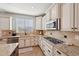 Open kitchen featuring a gas range, granite counters, and tile backsplash at 5779 S Penrose Dr, Gilbert, AZ 85298