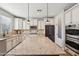 Spacious kitchen featuring white cabinetry, a center island, and modern appliances at 5779 S Penrose Dr, Gilbert, AZ 85298