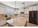 Bright kitchen with stainless steel appliances, a granite island, and abundant cabinet space at 5779 S Penrose Dr, Gilbert, AZ 85298