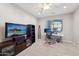 Well-lit office featuring a ceiling fan, large screen tv, and modern computer equipment at 5779 S Penrose Dr, Gilbert, AZ 85298