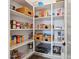 Walk-in pantry with ample shelving for storage, featuring organized baskets and containers at 5779 S Penrose Dr, Gilbert, AZ 85298