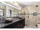 Stylish bathroom featuring a modern vanity with dual bowl sinks and glass-enclosed shower at 6533 E Beverly Ln, Scottsdale, AZ 85254