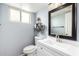 Bathroom featuring modern vanity, framed mirror, and decorative shelves at 6533 E Beverly Ln, Scottsdale, AZ 85254