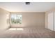 Bright bedroom with large window, neutral carpet, and plenty of space at 6533 E Beverly Ln, Scottsdale, AZ 85254