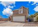 Suburban two story home with desert landscaping, an extra wide driveway and a two-car garage at 6533 E Beverly Ln, Scottsdale, AZ 85254