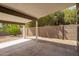 A covered patio with a concrete floor, block wall, and views of the yard at 6533 E Beverly Ln, Scottsdale, AZ 85254