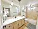 Well-lit bathroom featuring a large vanity, a spacious countertop, and neutral earth-tone tiling at 6841 N 3Rd Pl, Phoenix, AZ 85012