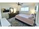 Neutral bedroom with a ceiling fan, natural light, and an ensuite bathroom at 6841 N 3Rd Pl, Phoenix, AZ 85012