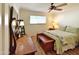 Comfortable bedroom with wood floors, ceiling fan, and large mirror at 6841 N 3Rd Pl, Phoenix, AZ 85012