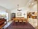 Bright dining room features a wood table for six, piano, and cabinet with glass doors at 6841 N 3Rd Pl, Phoenix, AZ 85012