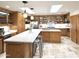 Spacious kitchen with wood cabinets, quartz countertops, and stainless steel appliances at 6841 N 3Rd Pl, Phoenix, AZ 85012