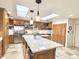 Bright kitchen featuring wood cabinets, stone floors, and stainless steel appliances at 6841 N 3Rd Pl, Phoenix, AZ 85012