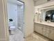 Well-lit main bathroom with a toilet, glass-enclosed shower and vanity with sink at 6841 N 3Rd Pl, Phoenix, AZ 85012