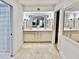 Elegant main bathroom with double sinks, neutral tile, and a glass-enclosed shower at 6841 N 3Rd Pl, Phoenix, AZ 85012