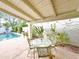 Inviting covered patio with a dining table and lush landscaping, overlooking the refreshing swimming pool at 6841 N 3Rd Pl, Phoenix, AZ 85012