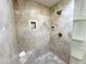 Beautiful tiled shower with built-in bench and recessed shelving, providing a luxurious bathing experience at 6841 N 3Rd Pl, Phoenix, AZ 85012