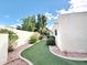 Low-maintenance side yard with artificial turf and decorative stone, offering a clean outdoor space at 6841 N 3Rd Pl, Phoenix, AZ 85012