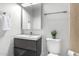 Modern bathroom vanity complemented by sleek fixtures, a mirrored cabinet, and a matching toilet at 749 E Montebello Ave # 228, Phoenix, AZ 85014