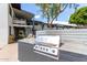 Community outdoor grill offers a stainless steel grill nestled into a block surround with blue skies overhead at 749 E Montebello Ave # 228, Phoenix, AZ 85014