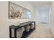 Hallway featuring decoratively styled console table with mirror and storage baskets, and tile flooring at 8108 E Paloma Ave, Mesa, AZ 85212