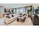 Comfortable living room with sectional sofa, wooden coffee table, light-colored rug, and patio doors at 8108 E Paloma Ave, Mesa, AZ 85212