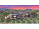 Desert estate features beautiful architecture, a winding drive, xeriscaping, and mountain views at 8154 E Tecolote Cir, Scottsdale, AZ 85266