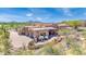 Beautiful Santa Fe style home boasts a private drive and desert landscaping with mountain views at 8154 E Tecolote Cir, Scottsdale, AZ 85266