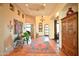 Inviting foyer with terracotta tile, arched doorways, art niches, and stylish chandelier at 8154 E Tecolote Cir, Scottsdale, AZ 85266