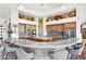 Spacious kitchen with island, breakfast bar, stainless appliances, marble counters, and custom wood cabinets at 8154 E Tecolote Cir, Scottsdale, AZ 85266
